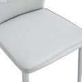 Four Light Gray Dining Chairs. A Medieval Modern Chair Made Of Pu Material With Soft Cushions And Silver Metal Legs. Suitable For Restaurants And Living Rooms Light Gray Pu