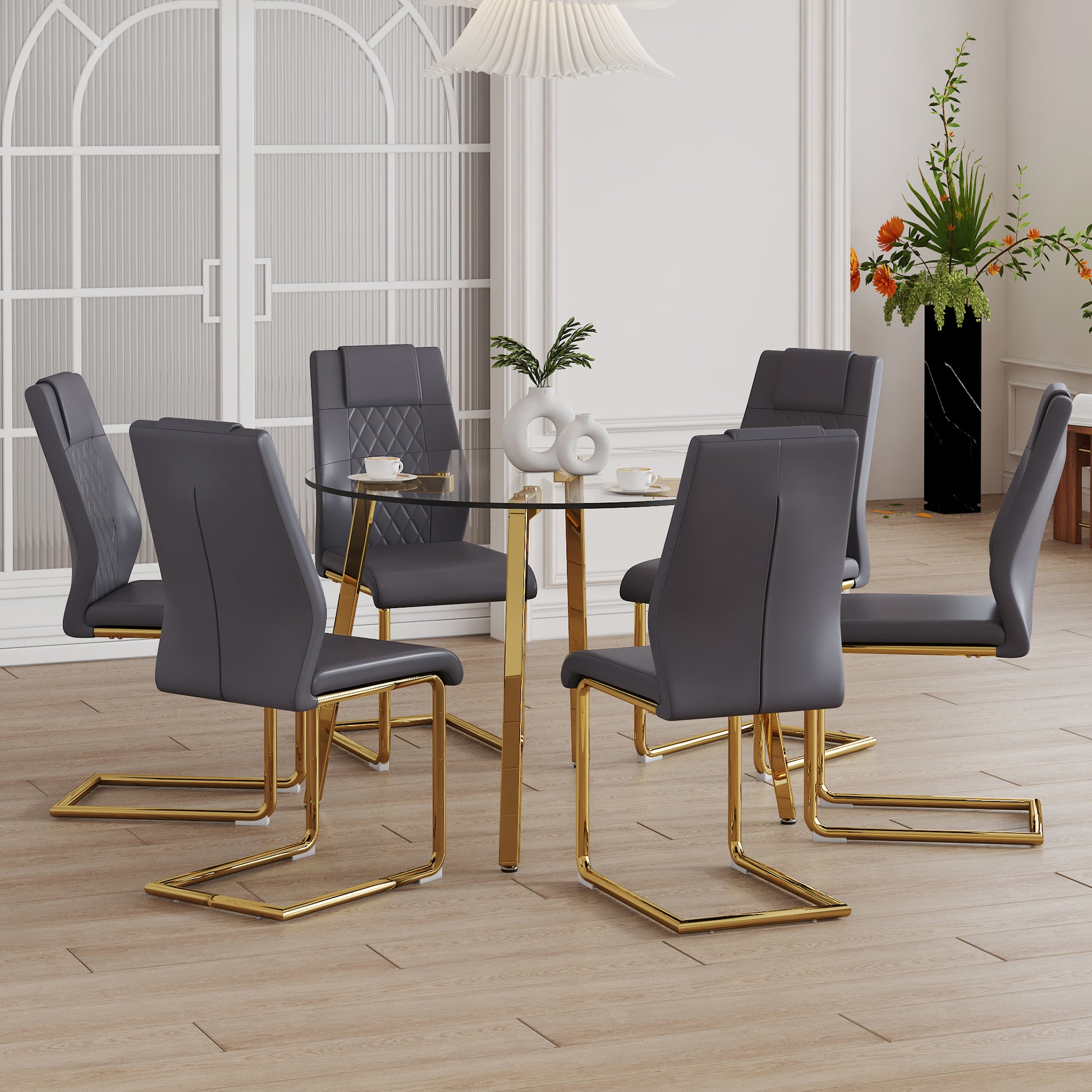 Table And Chair Set.A Modern Minimalist Style Round Clear Tempered Glass Table With Metal Legs.Paried With Dark Gray Chairs With Modern Pu Leather High Back Upholstered And C Tube Golden Legs. Transparent Seats 6 Glass